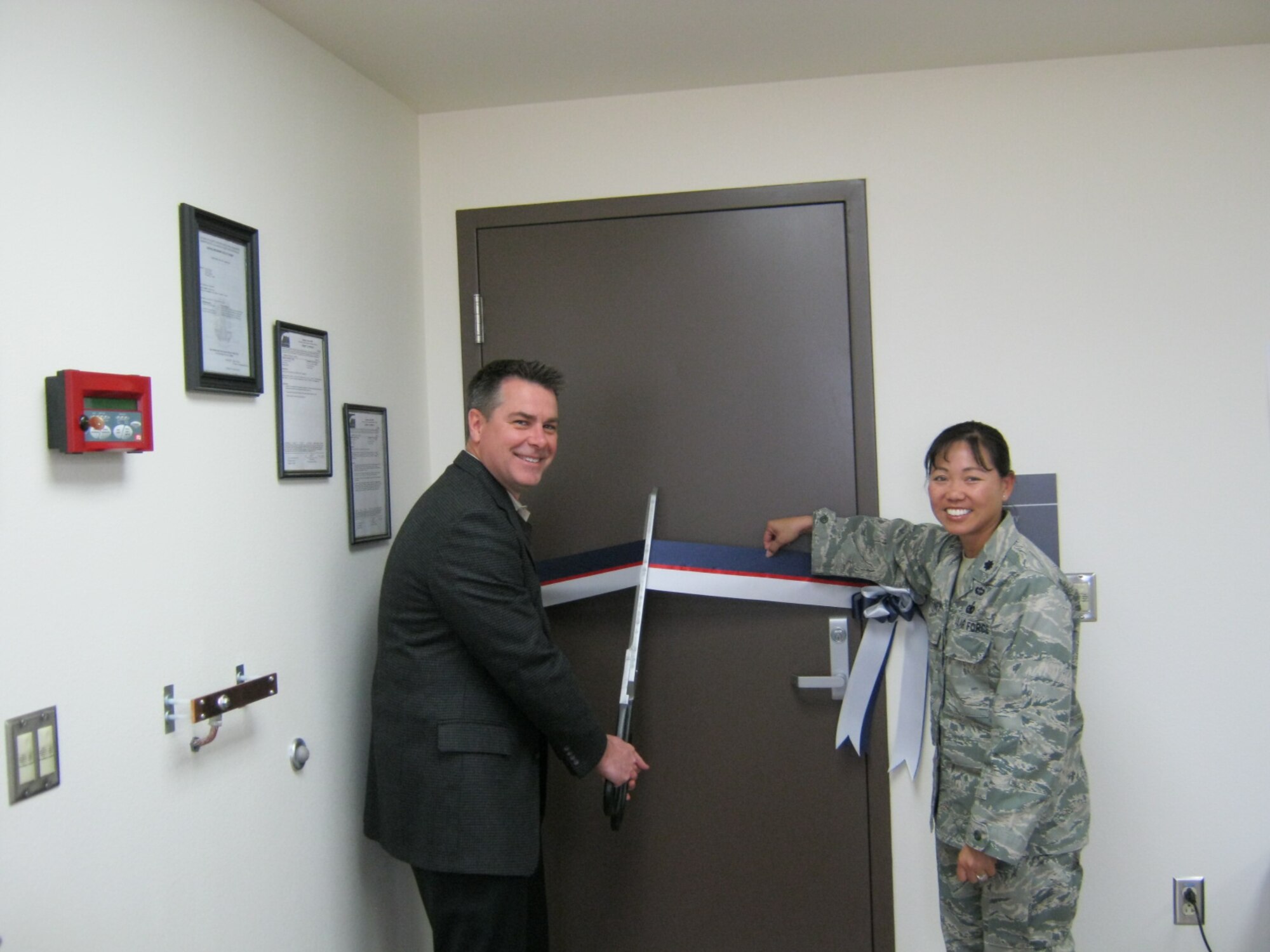 Cutting the Ribbon: Timothy Hughes, Aeronautical Systems Center Detachment 1 Acting Director of Air Force Plant 42, and Lt. Col. Tam Gaffney, Defense Logistics Agency Energy Americas West commander, officially dedicate the POL Laboratory Building April 13.