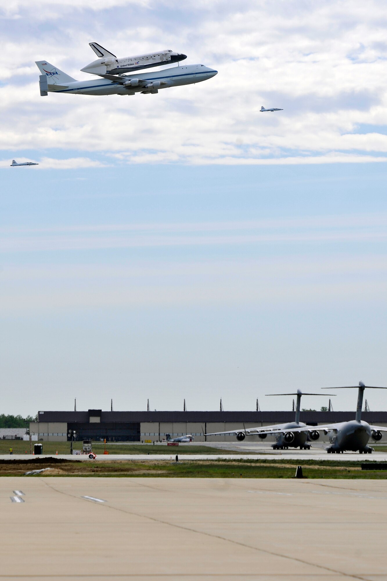 A shuttle carrier aircraft carrying the space shuttle Discovery flies above Joint Base Andrews, Md. on its final flight April 17. The retired shuttle landed at Washington Dulles International Airport for delivery to the National Air & Space Museum’s Udvar-Hazy Center.(U.S. Air Force Photo/ Senior Airman Perry Aston)