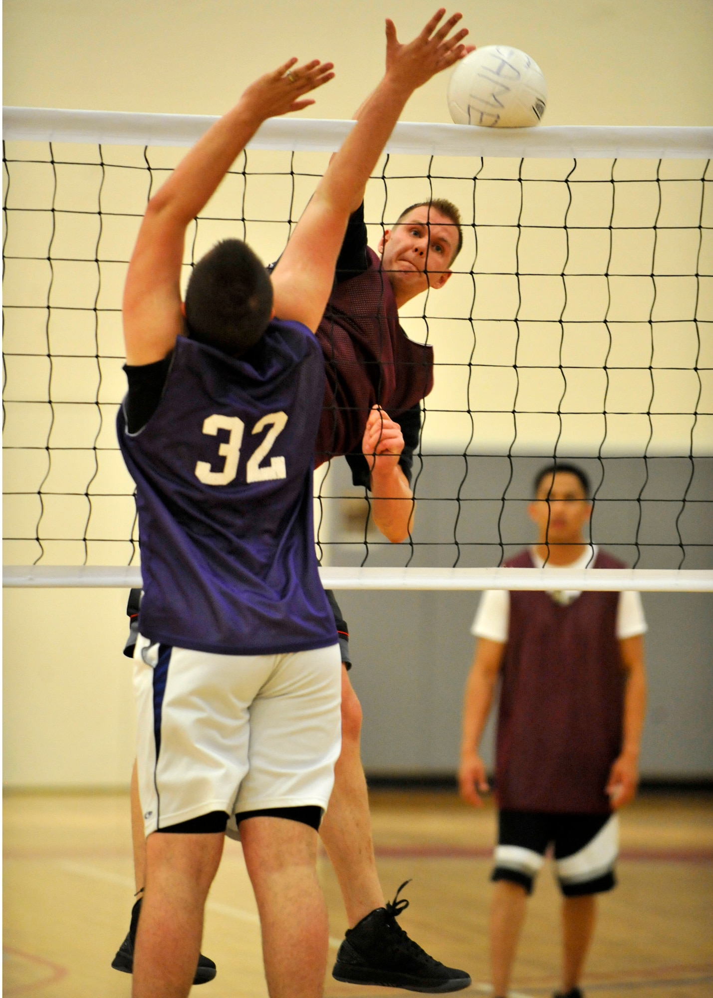 Ryan Mozingo, of the 436th Medical Group, slams home a kill as Don DeWitt, of the 436th Communications Squadron, tries to block during an intramural volleyball match at the Fitness Center April 16, 2012, on Dover Air Force Base, Del. The 436th MDG swept 436th CS 25-17 and 25-17. (U.S. Air Force photo by Tech. Sgt. Chuck Walker)