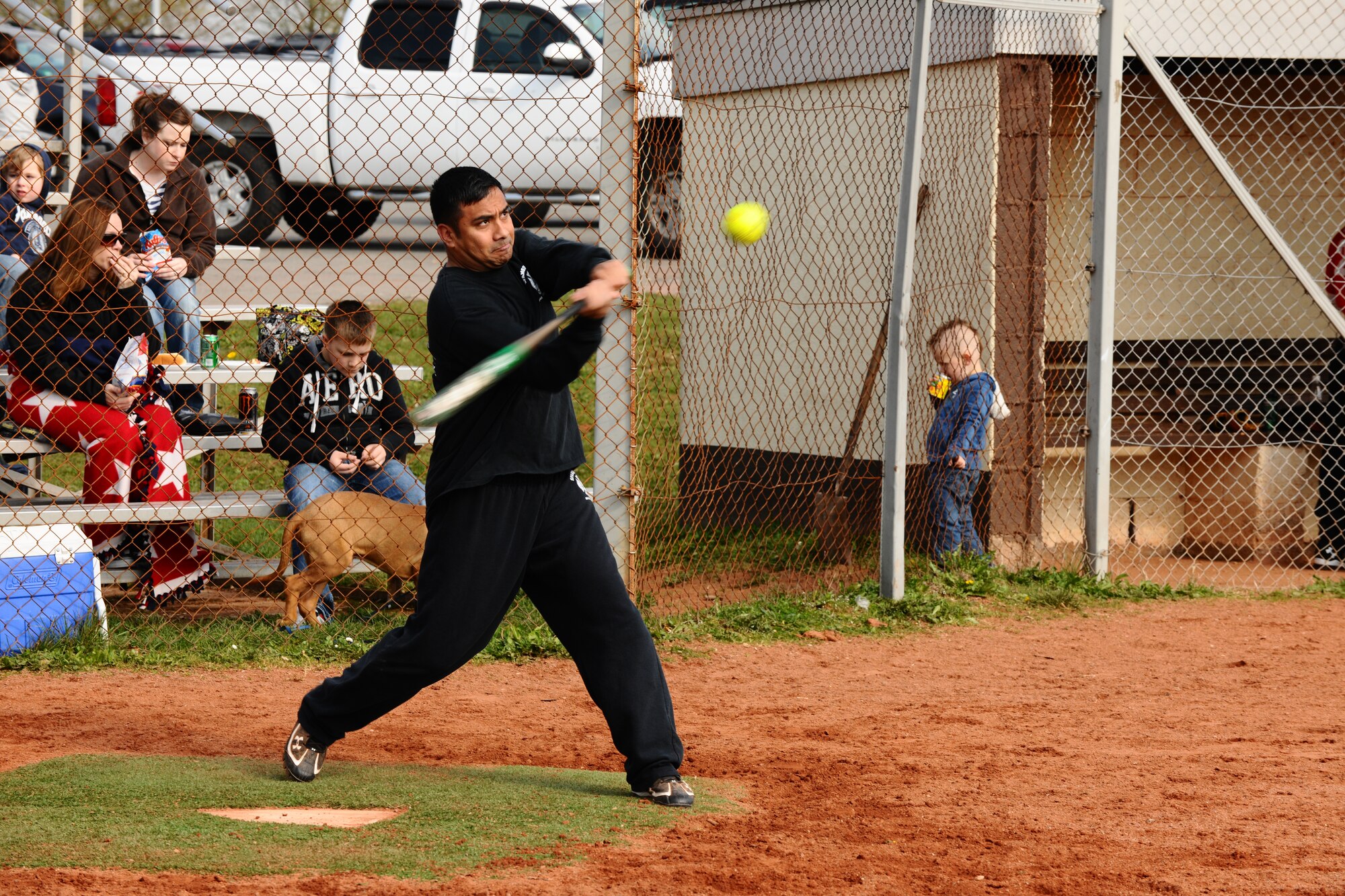 SPANGDAHLEM AIR BASE, Germany – Carlito Tacbas, 52nd Civil Engineer Squadron, swings at a softball during a softball tournament on Field 2 here April 14. The first 52nd Maintenance Operations Squadron sponsored softball tournament included more than 12 teams made up of military and family members 18 and older and is intended to prepare players for the upcoming intramural season. The 52nd Civil Engineer Squadron team beat the 470th Air Base Squadron 19-17 in the final game of the double-elimination tournament. (U.S. Air Force photo by Airman 1st Class Dillon Davis/Released)