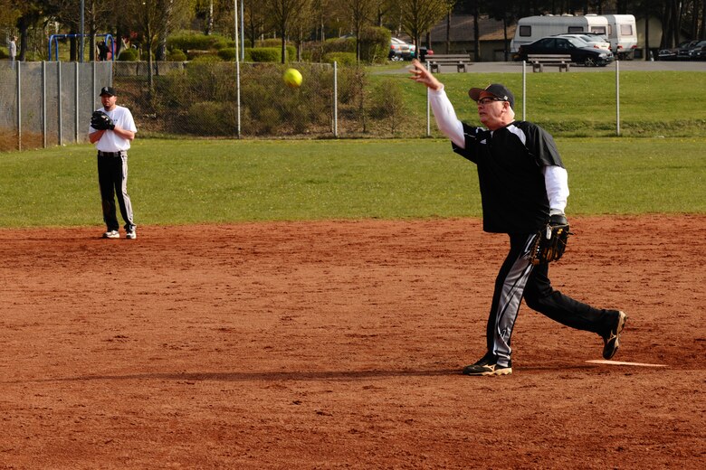 SPANGDAHLEM AIR BASE, Germany – George Riebling, Joint Force Command Brunnsum NATO AWACS Program Management Agency, pitches a softball during a softball tournament on Field 2 here April 14. The first 52nd Maintenance Operations Squadron sponsored softball tournament included more than 12 teams made up of military and family members 18 and older and is intended to prepare players for the upcoming intramural season. The 52nd Civil Engineer Squadron team beat the 470th Air Base Squadron 19-17 in the final game of the double-elimination tournament. (U.S. Air Force photo by Airman 1st Class Dillon Davis/Released)