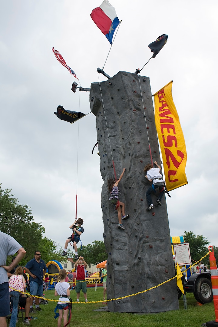 Children race each other on the three-story climbing wall at the annual Famaganza celebration April 14 at Joint Base San Antonio-Randolph, Texas. Famaganza is a yearly family celebration that includes performances, games, prizes and a book fair. (U.S. Air Force photo by Benjamin Faske)