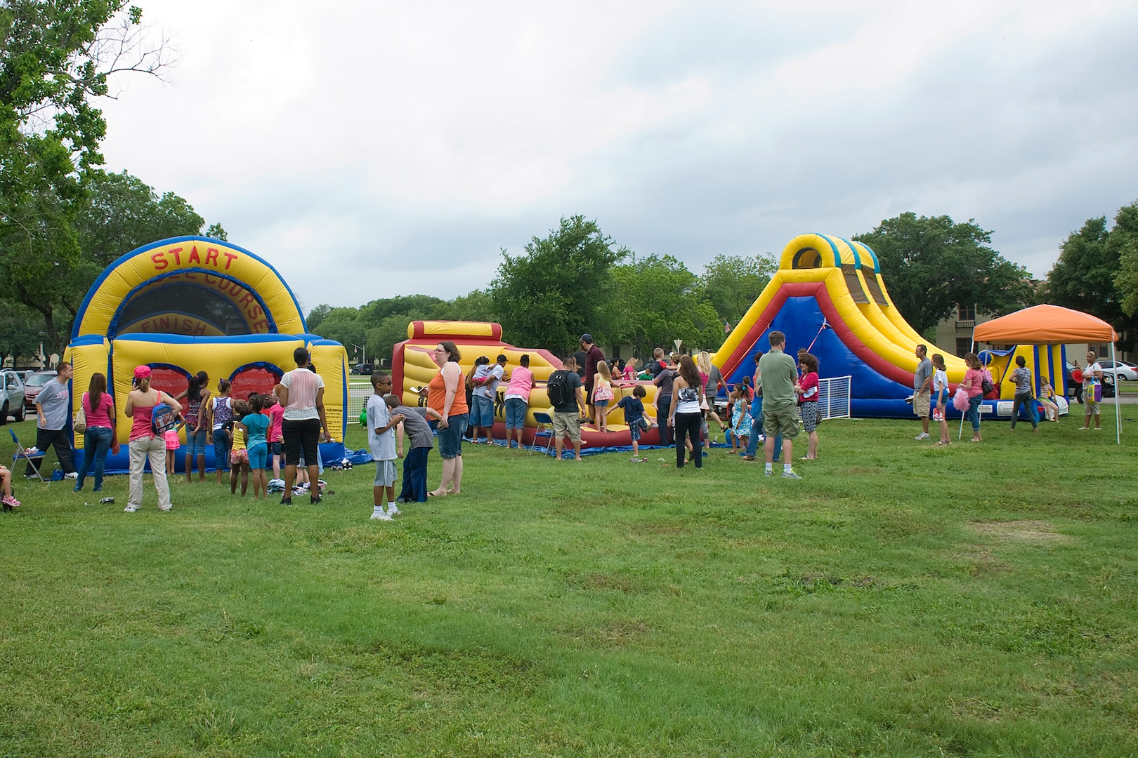Children line up to jump on three of the oversized inflatable moon bounces April 14 as part of Famaganza at Joint Base San Antonio-Randolph, Texas.  Famaganza is a yearly family celebration that includes performances, games, prizes and a book fair. (U.S. Air Force photo by Benjamin Faske)
