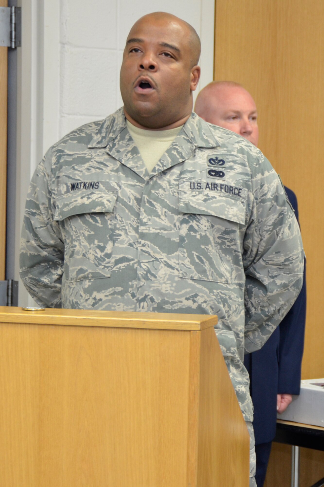 Tech. Sgt. Maurice L. Watkins, utilities specialist, sings the Star Spangled Banner, during a retirement ceremony for Master Sgt. Hilda Elaine Moses, 94th Civil Engineer Squadron health and safety officer, April 14. Moses celebrated 23 years of dedicated service to the U.S. Air Force. (U.S. Air Force photo/Master Sgt. James Branch)