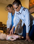 Lt. Col. Patricia John (right), 359th Medical Group chief nurse, and Staff Sgt. Andria King, Dental Logistics NCO in charge, perform mandatory CPR training at the base clinic April 2. (U.S. Air Force Photo by Benjamin Faske) 