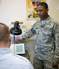 Airman 1st Class James Johnson, 359th Medical Group medical technician, performs an eye exam at the Joint Base San Antonio-Randolph Medical Clinic April 2. Randolph celebrated Nurse Medical Technician Appreciation Week May 7-11. (U.S. Air Force Photo by Benjamin Faske) 