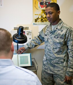 Airman 1st Class James Johnson, 359th Medical Group medical technician, performs an eye exam at the Joint Base San Antonio-Randolph Medical Clinic April 2. Randolph celebrated Nurse Medical Technician Appreciation Week May 7-11. (U.S. Air Force Photo by Benjamin Faske) 
