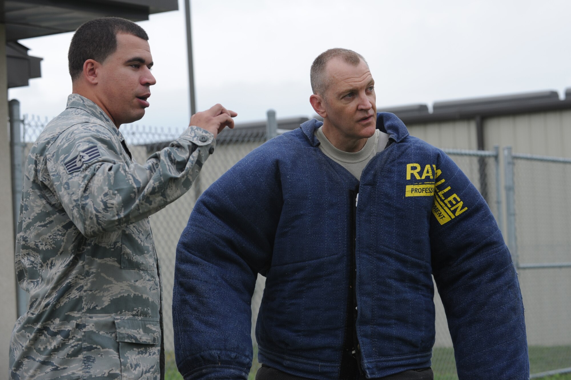 GOODFELLOW AIR FORCE BASE, Texas -- Staff Sgt. Jonathan Halcomb, 17th Security Forces Squadron military working dog handler, gives Chief Master Sgt. Scott Lumpkin, 17th Training Wing Command Chief, a safety brief before being “attacked” by Rocky, 17th SFS MWD, April 13. Chief Lumpkin was touring 17th SFS and agreed to put on the protective suit. (U.S. Air Force photo/Staff Sgt. Laura R. McFarlane)