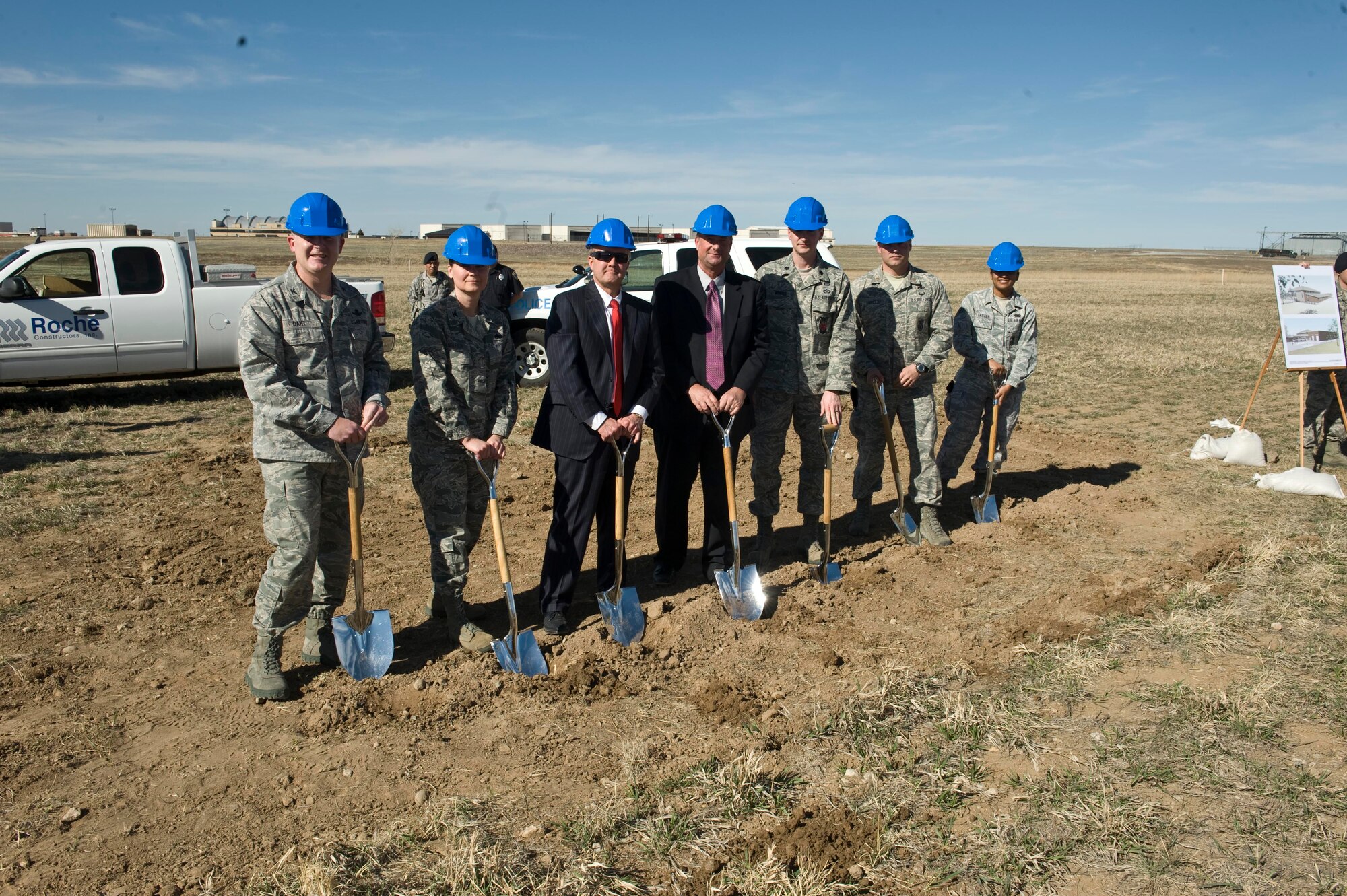 BUCKLEY AIR FORCE BASE, Colo -- Colonel Daniel Dant, 460th Space Wing commander, left, Col. Deirdre Mahon, 460th Mission Support Group commander, left, join the rest of the officiating party in the ground breaking of the new 460th Security Forces facility, Mar. 15, 2012. The new Security Forces Facility will be a two-story 35,175 square foot masonry building which will house all the base security operations including law enforcement, armory, base information and security functions. (U.S. Air Force photo by Airman 1st Class Riley Johnson)
