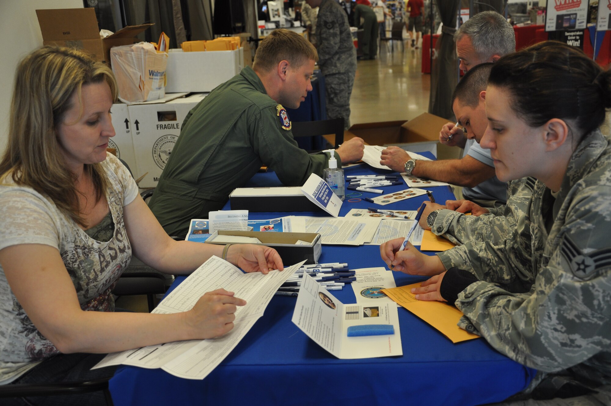 Kelly Lawrence, 19th Medical Group registered nurse for the Family Health Center and coordinator of the base bone-marrow drive, explains volunteering directions to a Team Little Rock Member April 13, 2012, at Little Rock Air Force Base, Ark. Once a person completes the swabbing process, their name will be in the donor registry until they turn 61 years old. (U.S. Air Force photo by Airman 1st Class Regina Agoha)