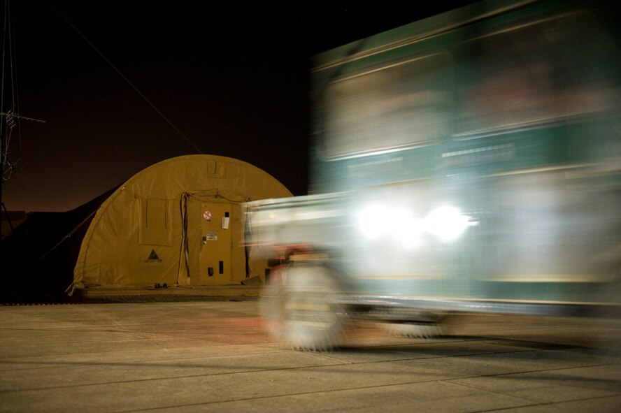 Members of the 71st Expeditionary Rescue Squadron drive to their aircraft to respond to a category alpha aeromedical evacuation mission, Camp Bastion, Afghanistan, April 9, 2012. The mission of the 71st EQRS is to provide personnel recovery, casualty evacuation and aeromedical evacuation assets from hostile locations. The 71st EQRS is the only fixed wing aircraft squadron dedicated to medical evacuation missions in Afghanistan. (U.S. Air Force photo by Staff Sgt. Greg Biondo)