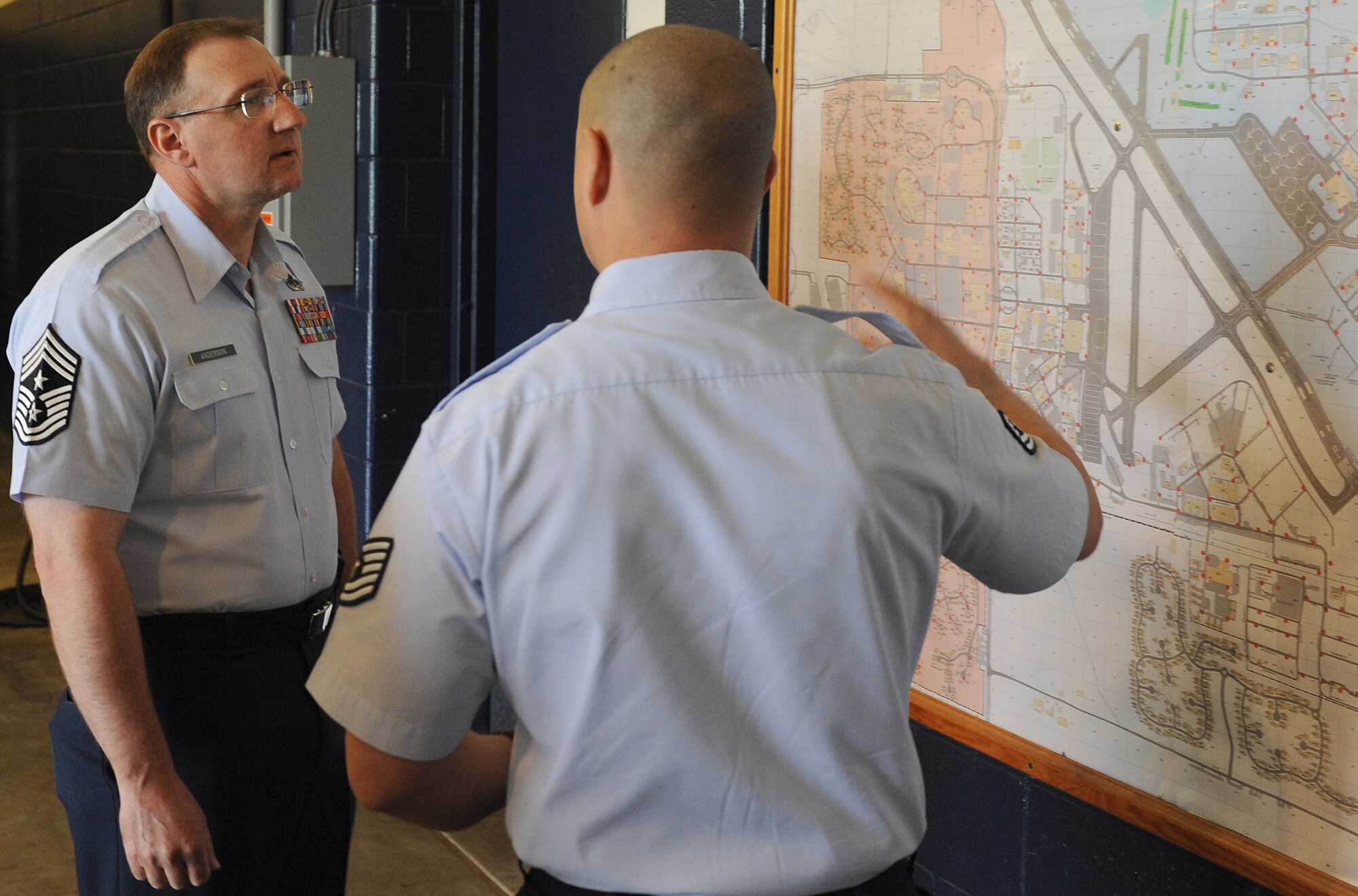 Tech Sgt. Lincoln Ratliff, 375th Civil Engineer Squadron fire fighter, briefs Marty Anderson, 375th Air Mobility Wing command chief, April 16 at Scott Air Force Base, Ill.  Ratliff informed Chief Anderson on the area of responsibility that Team Scott fire department has, as well as the procedure of the 911 call. (U.S. Air Force photo/Airman 1st Class Divine Cox)
