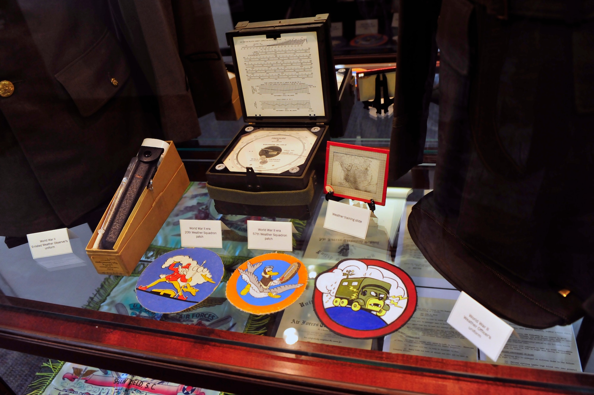 Old weather squadron patches and forecasting equipment are displayed in the 28th Operational Weather Squadron’s lobby, Shaw Air Force Base, S.C., April 6, 2012 Volunteers from the 28th OWS created an Air Force memorabilia display in their lobby to help squadron members and visitors gain a sense of pride in their heritage. (U.S. Air Force photo by Senior Airman Daniel Phelps/Released)