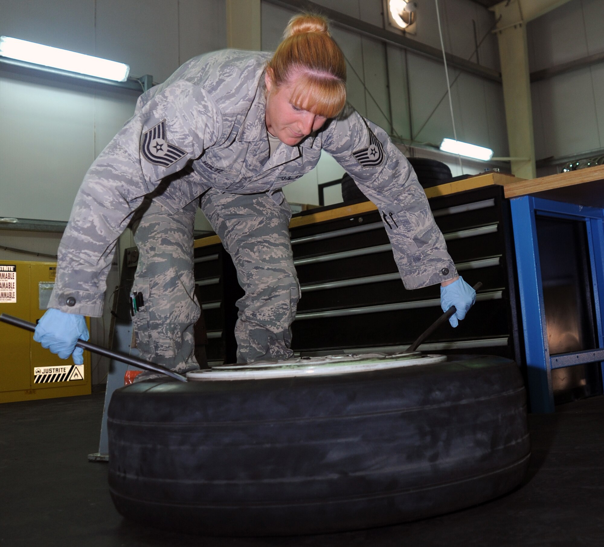 SOUTHWEST ASIA - Tech. Sgt. Tessa Holtz disassembles an F-15 Eagle wheel April 10, 2012. The Needsport, Ore., native is part of a new wheel and tire shop at the 380th Air Expeditionary Wing. She leads a team of six Airmen who provide maintenance to wheel and tire assemblies for fighter aircraft deployed to the 380th AEW. Holtz is deployed from Mountain Home Air Force Base, Idaho. (U.S. Air Force photo/Staff Sgt. J.G. Buzanowski)