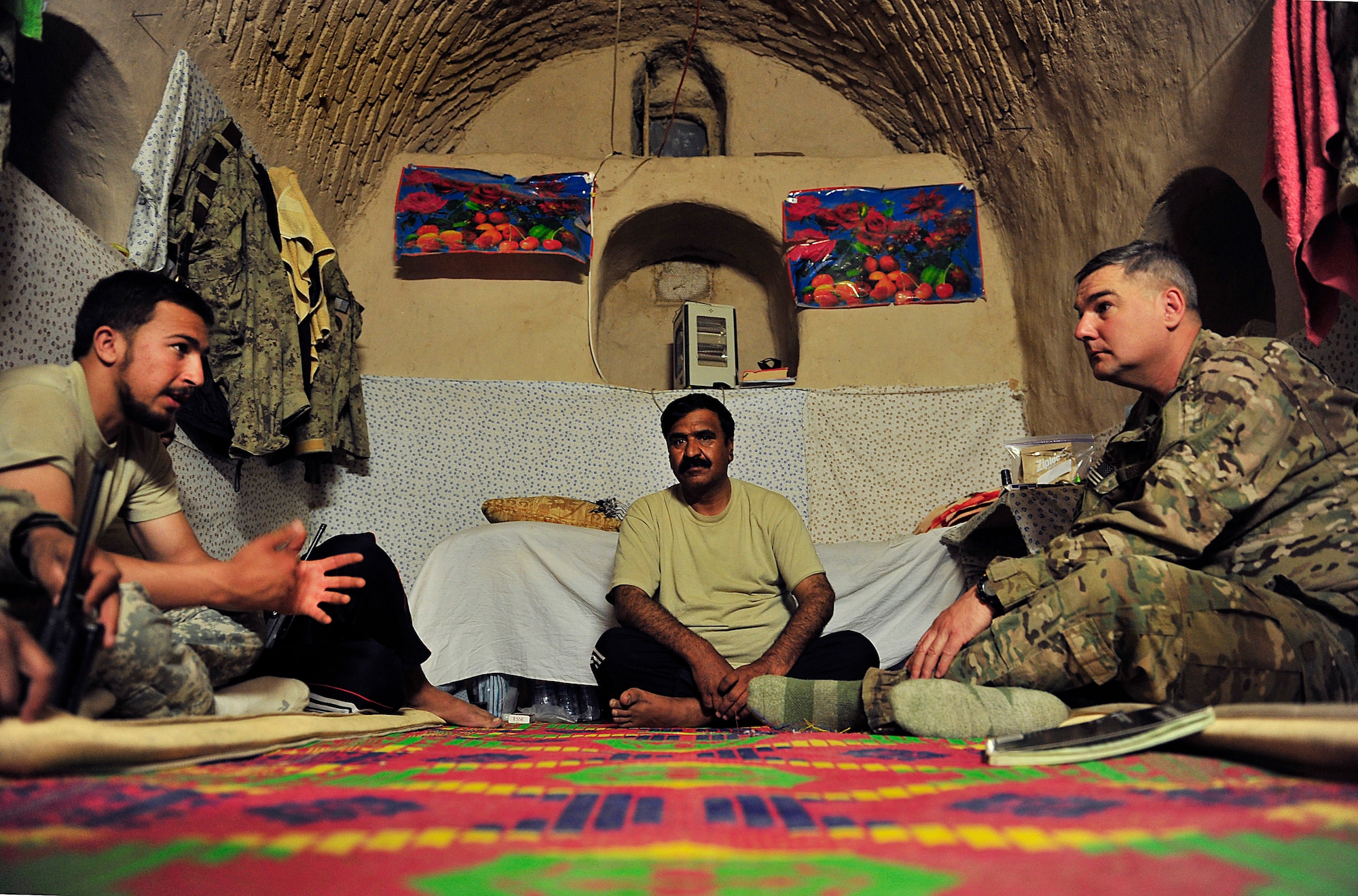 U.S. Air Force Lt. Col. Joel Briske, Afghan National Civil Order Police Combat Advisor Team commander, meets with Col. Zyeer, the ANCOP 2nd Kandak 3rd Brigade commander in his temporary home at Forward Operating Base Whitehouse in Kajaki, Afghanistan, April 5, 2012. When meeting with his ANCOP counterpart, Briske is assisted by a linguist. The ANCOP Combat Advisor Team is comprised of four Air Force officers that act as lead advisers and a group of highly trained Soldiers that are responsible for the team's security. It is the team's mission to help train and advise the ANCOP 2/3 Kandak on how to secure and protect their country from insurgents. (U.S. Air Force photo by Staff Sgt. Sara Csurilla)