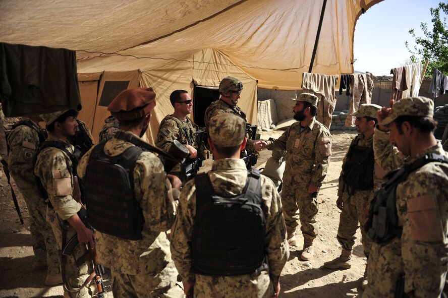 Second Kandak, 3rd Brigade, Afghan National Civil Order Police meet with members of the ANCOP Combat Advisor Team at one of the many patrol bases in Kajaki, Afghanistan, April 5, 2012. The ANCOP Combat Advisor Team is comprised of four Air Force officers that act as lead advisers and a group of highly trained Soldiers that are responsible for the team's security. It is the team's mission to help train and advise the ANCOP 2/3 Kandak on how to secure and protect their country from insurgents. (U.S. Air Force photo by Staff Sgt. Sara Csurilla)
