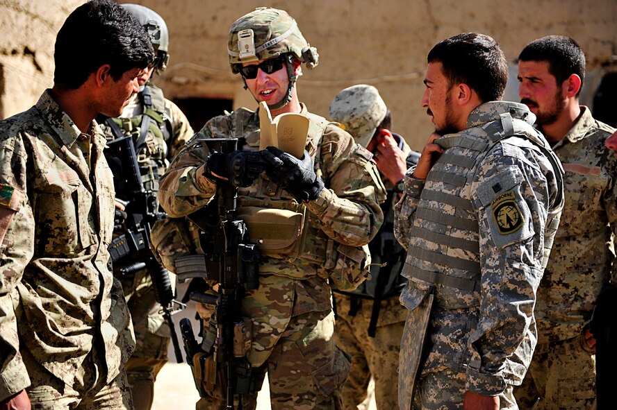 U.S. Air Force Capt. Robert Fekete, senior logistics advisor with an Afghanistan National Civil Order Police Combat Advisor Team, talks to an ANCOP member during a routine mission to advise and assist members of the ANCOP 2/3 Kandak in Kajaki, Afghanistan, April 5, 2012. The ANCOP Combat Advisor Team is comprised of four Air Force officers that act as lead advisers and a group of highly trained Soldiers that are responsible for the team's security. It is the team's mission to help train and advise the ANCOP 2/3 Kandak on how to secure and protect their country from insurgents. (U.S. Air Force photo by Staff Sgt. Sara Csurilla)