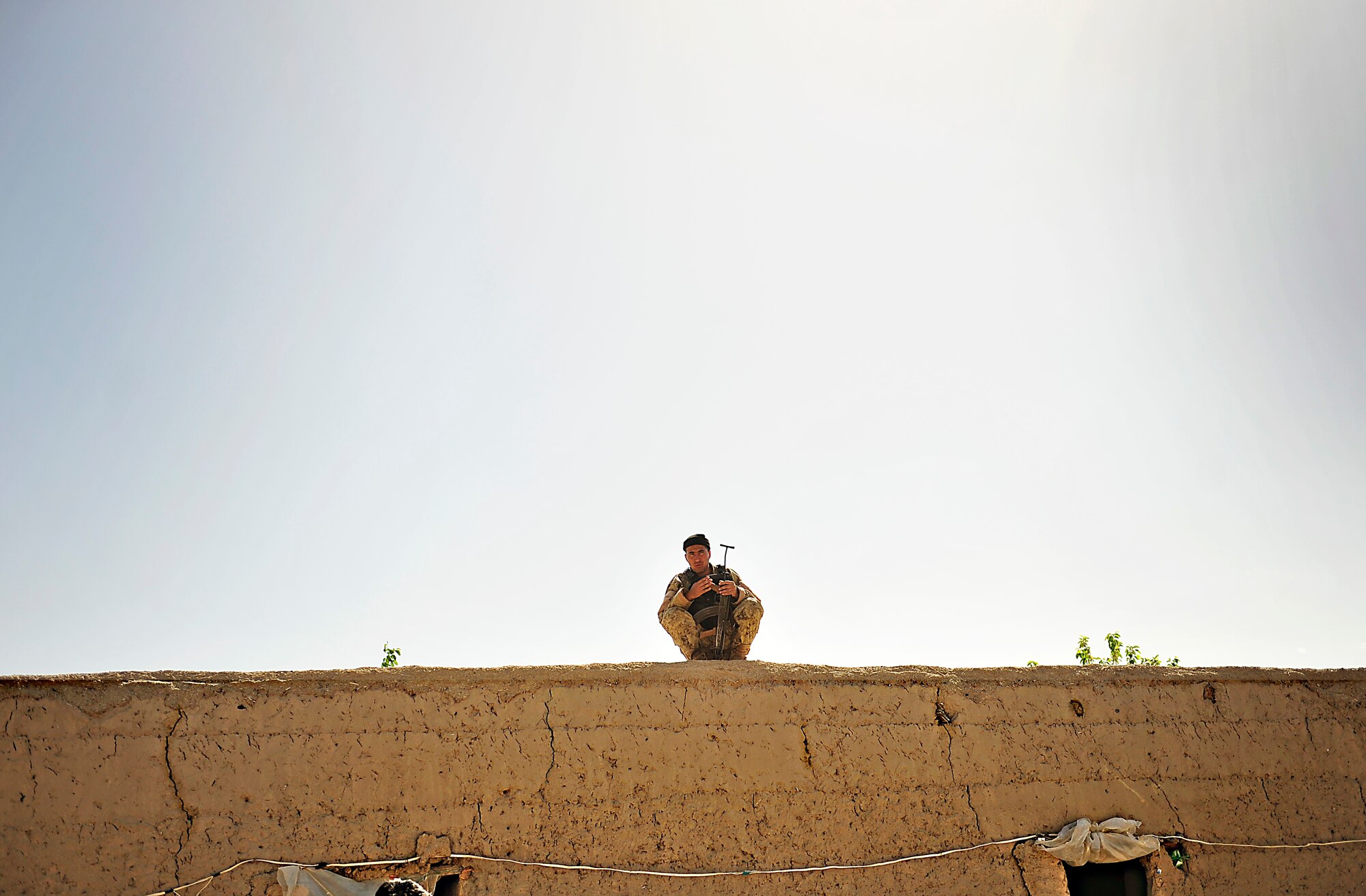 A member of the 2nd Kandak, 3rd Brigade, Afghan National Civil Order Police member rests on a roof at one of the many patrol bases during a visit from the ANCOP Combat Advisor Team in Kajaki, Afghanistan, April 5, 2012. The ANCOP Combat Advisor Team is comprised of four Air Force officers that act as lead advisers and a group of highly trained Soldiers that are responsible for the team's security. It is the team's mission to help train and advise the ANCOP 2/3 Kandak on how to secure and protect their country from insurgents. (U.S. Air Force photo by Staff Sgt. Sara Csurilla)