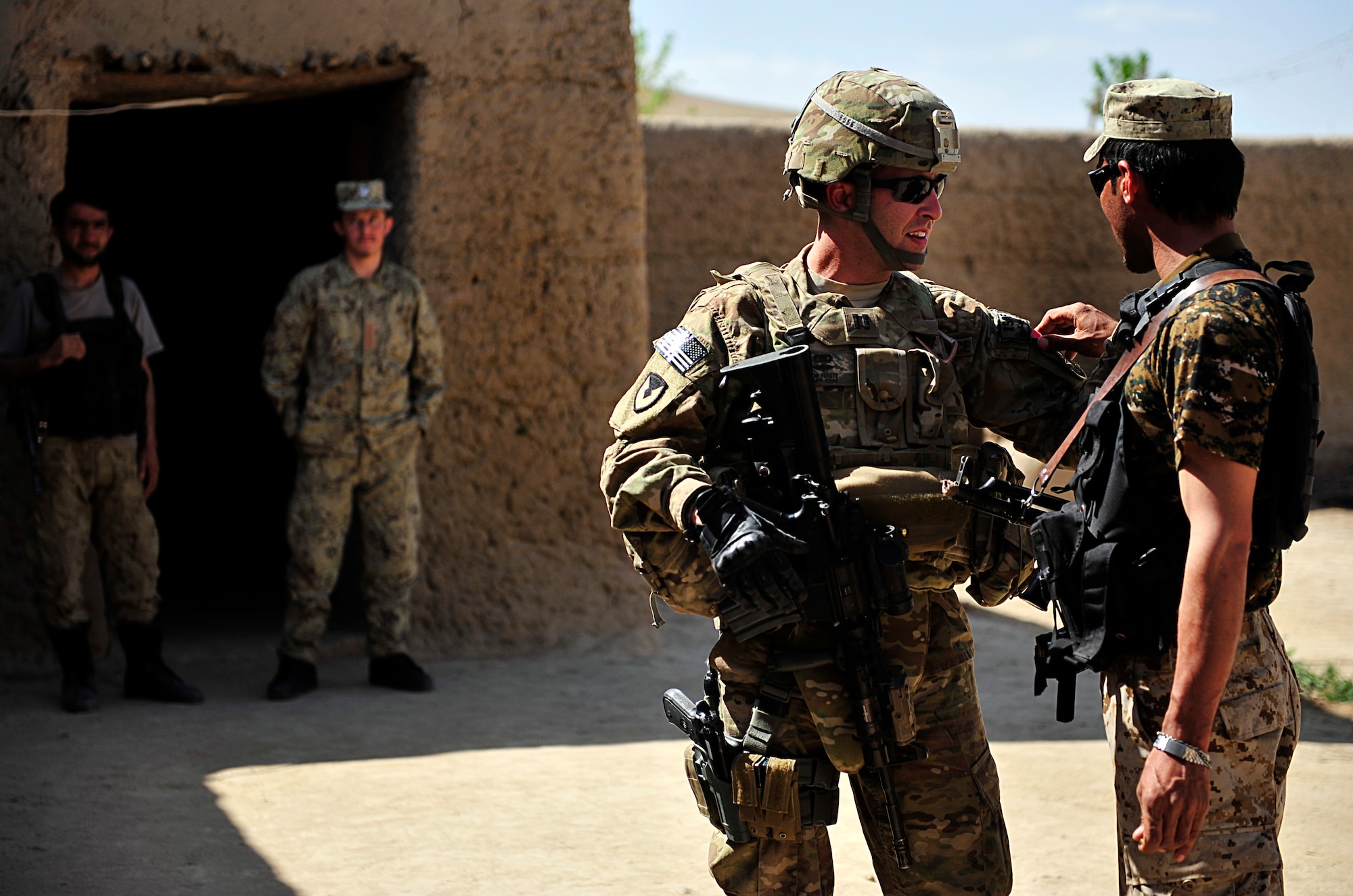U.S. Air Force Capt. Robert Fekete, senior logistics advisor with an Afghanistan National Civil Order Police Combat Advisor Team, talks to an ANCOP member during a routine mission to advise and assist members of the ANCOP 2nd Kandak, 3rd Brigade, in Kajaki, Afghanistan, April 5, 2012. The ANCOP Combat Advisor Team is comprised of four Air Force officers that act as lead advisers and a group of highly trained Soldiers that are responsible for the team's security. It is the team's mission to help train and advise the ANCOP 2/3 Kandak on how to secure and protect their country from insurgents. (U.S. Air Force photo by Staff Sgt. Sara Csurilla)