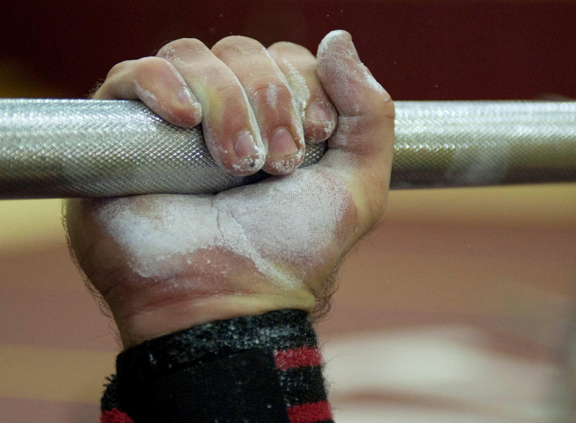 Adam Plummer grips a bench-press bar holding 230 pounds during a powerlifting competition April 14, 2012, at Incirlik Air Base, Turkey. Plummer took third place overall in the competition, which is his first powerlifting competition. (U.S. Air Force photo by Senior Airman Anthony Sanchelli/Released)