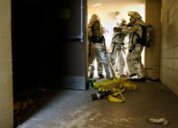 Firefighters from the 8th Civil Engineer Squadron prepare to enter an old dormitory as part of a simulated structural fire exercise on Kunsan Air Base, Republic of Korea, April 17, 2012. The exercise was part of the fire department’s Consolidated Unit Inspection by the Pacific Air Forces Inspector General team. (U.S Air Force photo/Senior Airman Jessica Hines)