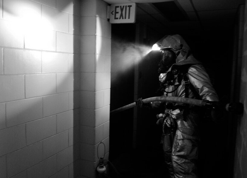 A firefighter from the 8th Civil Engineer Squadron hauls a water hose up to the second floor during a simulated structural fire exercise on Kunsan Air Base, Republic of Korea, April 17, 2012. The exercise was part of the fire department’s Consolidated Unit Inspection by the Pacific Air Forces Inspector General team. (U.S Air Force photo/Senior Airman Jessica Hines)