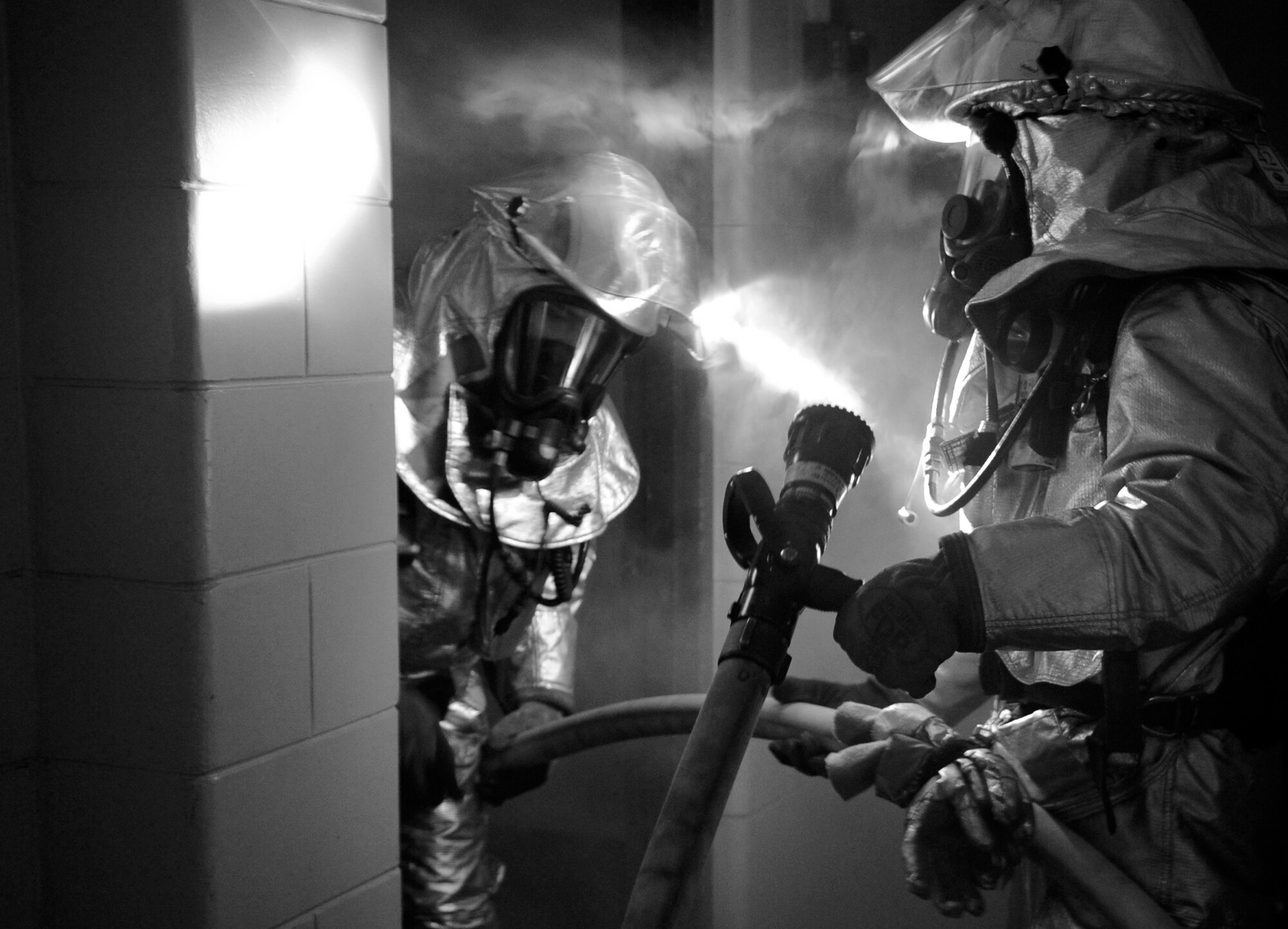 Firefighters from the 8th Civil Engineer Squadron respond to a simulated structural fire on Kunsan Air Base, Republic of Korea, April 17, 2012. The Pacific Air Forces Inspector General team is currently inspecting all aspects of Wolf Pack operations and testing Airmen’s on-the-job skills. (U.S Air Force photo/Senior Airman Jessica Hines)