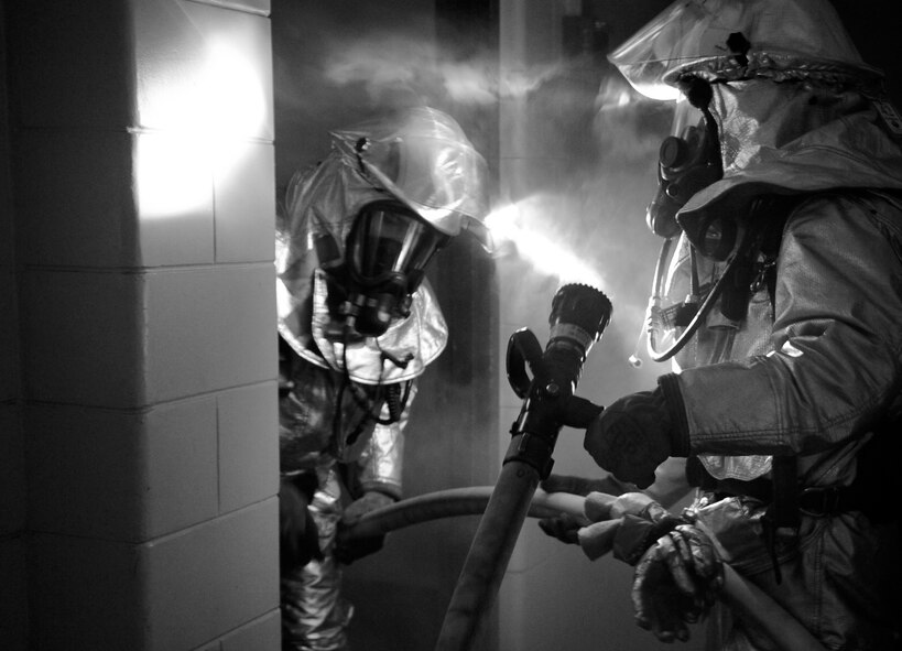 Firefighters from the 8th Civil Engineer Squadron respond to a simulated structural fire on Kunsan Air Base, Republic of Korea, April 17, 2012. The Pacific Air Forces Inspector General team is currently inspecting all aspects of Wolf Pack operations and testing Airmen’s on-the-job skills. (U.S Air Force photo/Senior Airman Jessica Hines)