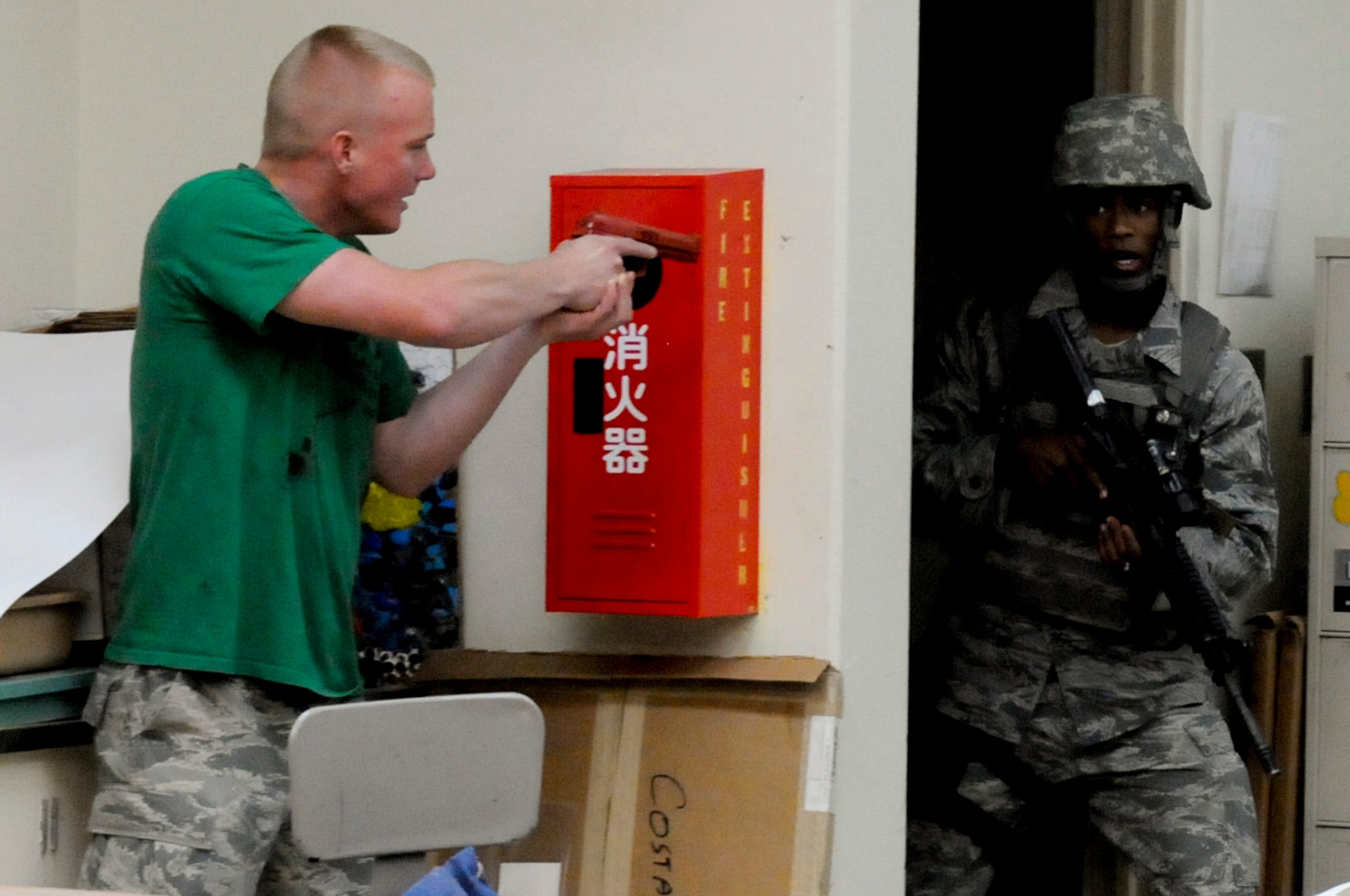 An "active shooter" prepares to ambush 18th Security Forces Squadron members during a Pacific Air Forces High Risk Response Training scenario on Kadena Air Base, Japan, April 12, 2012. The course takes the students through newly developed tactics and techniques grounded in contemporary Special Weapons and Tactics (SWAT) training. (U.S. Air Force photo by Airman 1st Class Tara A. Williamson/Released)
