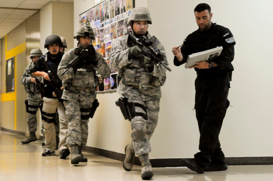 Tyler Hare, Analytic Services senior analyst with the Asymmetric Threat Division, reviews a team of military law enforcement members during a Pacific Air Forces High Risk Response Training active-shooter scenario on Kadena Air Base, Japan, April 12, 2012. Military police members from each U.S. military branch, along with civilian counterparts, participated in the five-day train-the-trainer program. (U.S. Air Force photo by Airman 1st Class Tara A. Williamson/Released)