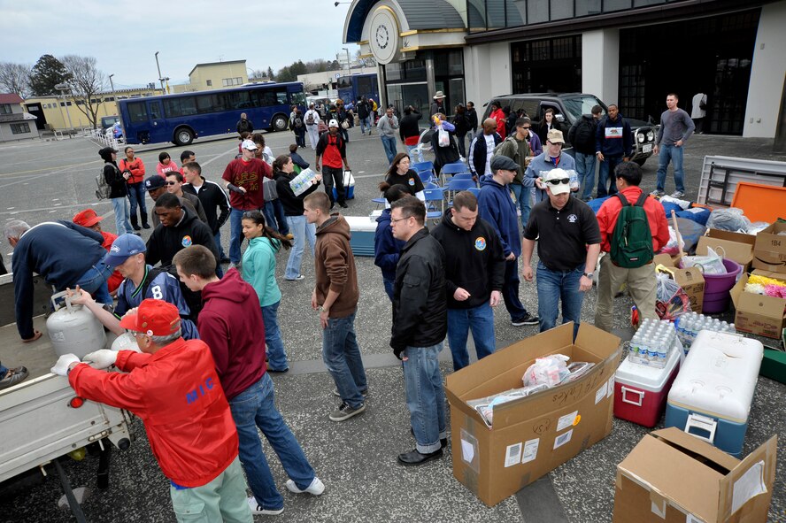 Members of the Misawa Air Base community and Misawa International Club set up for a Mini-American Day event at Hanamaki, Japan, April 14, 2012. More than 50 people from Misawa Air Base came out to support the event. The Mini-American Day was put on for the people displaced from their homes in the Iwate Prefecture, Japan, by the earthquake and subsequent tsunami of March 11, 2011. (U.S. Air Force photo by Staff Sgt. Nathan Lipscomb/Released)