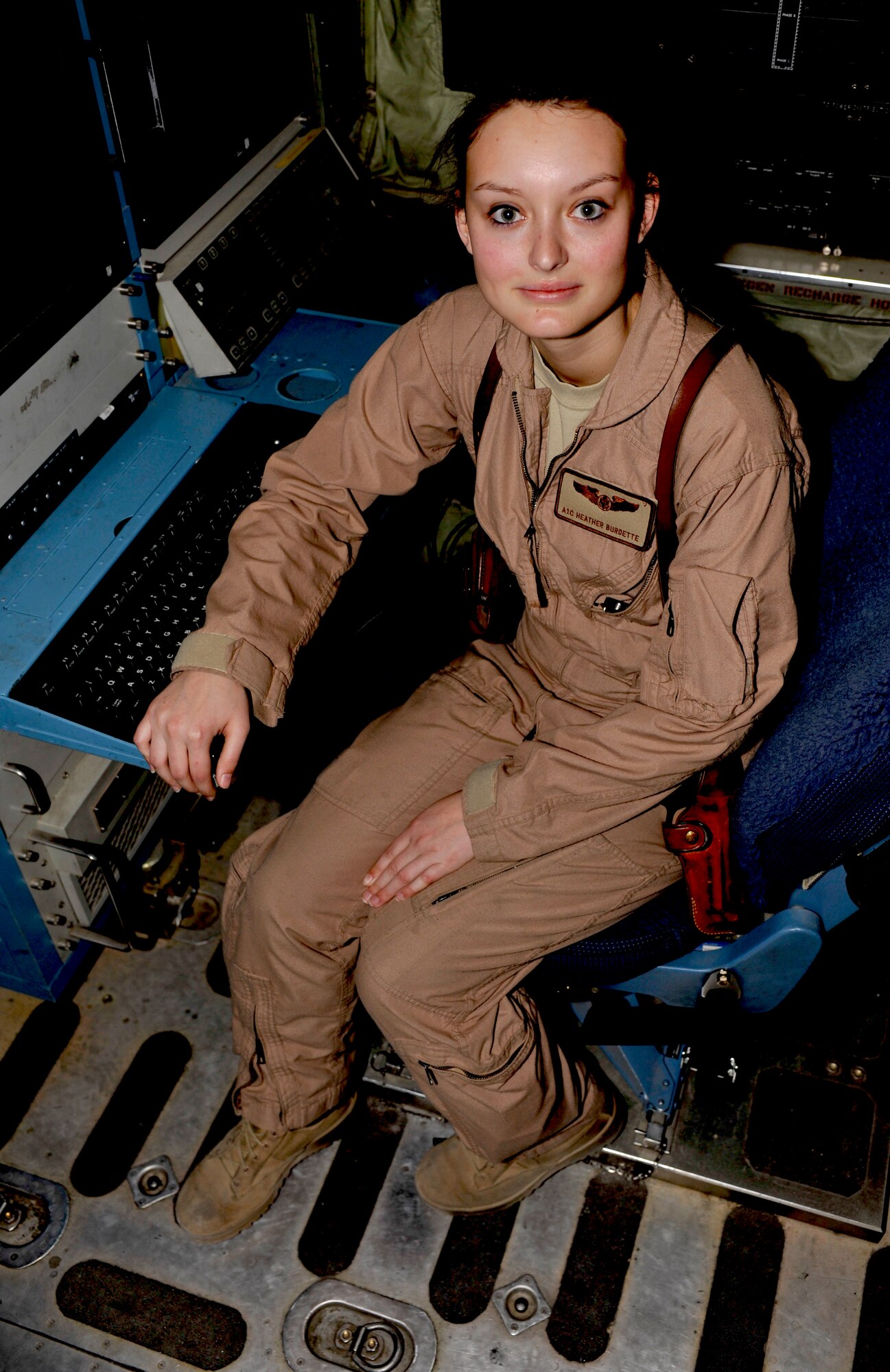 Airman 1st Class Heather Burdette poses in her seat on an EC-130 at Bagram Airfield, Afghanistan, April 16, 2012. Burdette is an EC-130H airborne maintenance technician with the 41st Expeditionary Electronic Combat Squadron and is deployed from Davis-Monthan Air Force Base, Ariz. (U.S. Air Force photo/ Airman 1st Class Ericka Engblom)