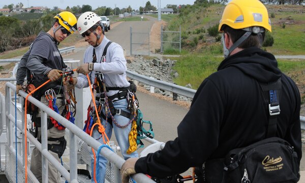 CALIFORNIA — U.S. Army Corps of Engineers Sacramento District engineers and climb team members (from left) Christopher Abela, Charles Jeung and Levi Bowers prepare their climbing ropes and equipment during a inspection of the tainter gates at New Hogan Dam, near Valley Springs, Calif., April 10, 2012. Tainter gates are a type of flood gate used in dams to control water flow. New Hogan Dam reduces flood risk to the city of Stockton and stores water used for irrigation, drinking and hydroelectric power. 
