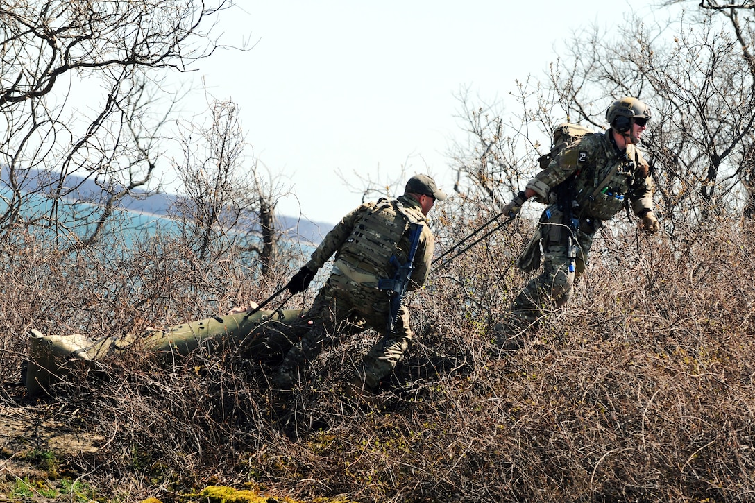 Air Force pararescue jumpers and air crew members move a simulated casualty while conducting casualty recovery training at Plum Island Animal Disease Center, N.Y., April 13, 2012.