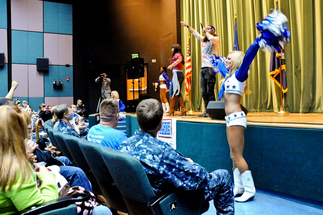 Singer/songwriter/actress Diana DeGarmo, singer/songwriter/actor Ace Young, and Dallas Cowboy cheerleaders Kelsi Reich, Brittany Evans and Allyson Traylor get the crowd of several hundred troops and their families dancing int heir seats during the second stop of the USO spring tour in Naples, Italy, April 16, 2012.