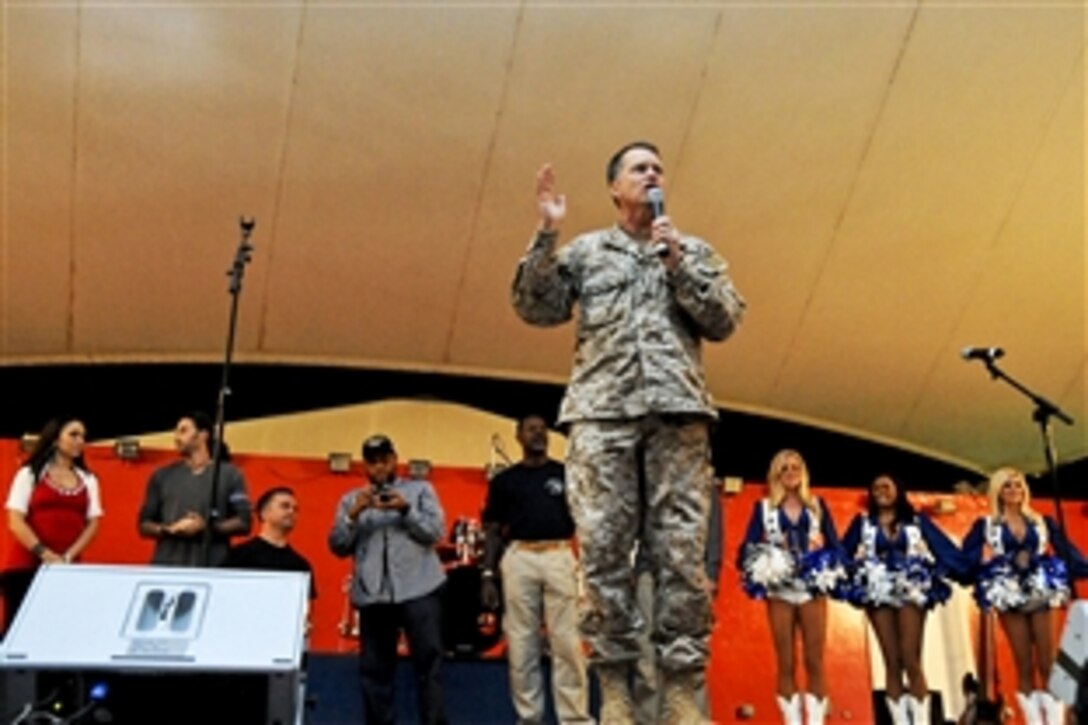 U.S. Navy Adm. James A. Winnefeld Jr., vice chairman of the Joint Chiefs of Staff, introduces the team of celebrities on the USO spring tour as they visit troops in Southwest Asia, April 17, 2012.  Several thousand U.S. troops and coalition partners listened as the celebrities spoke, sang and took photos with fans.