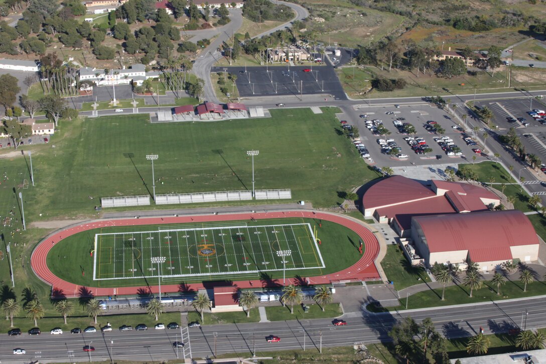 After four months of construction, the state of the art, all-weather track and artificial turf football field are officially open to Camp Pendleton residents. The track, adjacent to the Paige Fieldhouse on Mainside, was officially opened during a ribbon cutting ceremony, April 26. The new track and field are more durable than before and will improve quality of life for Marines, Sailors and their families.