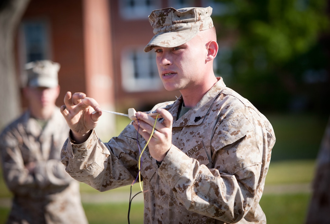 Sgt. Mark Caulk an instructor from Pekin, Ill., with II Marine Expeditionary Force Headquarters Group, teaches a course on the different types of preasure plates and detonation devices most commonly used in improvised explosive devices, during counter IED awareness training, April 17, at Camp Lejeune, N.C. The training provided participants with a look at what tools and techniques are available to counter the threat of roadside bombs during deployment.