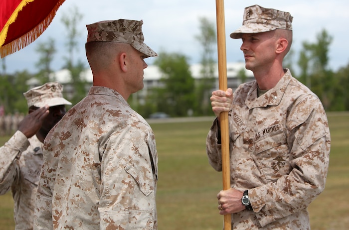Lt. Col. Matthew B. Reuter (right) prepares to pass the Combat Logistics Battalion 22 organizational flag to Lt. Col. William P. Carroll during a change of command ceremony at Soifert Field aboard Camp Lejeune, N.C., April 18, 2012. The passing of the flag symbolizes the complete transfer of authority. (U.S. Marine Corps photo by Sgt. Justin J. Shemanski)
