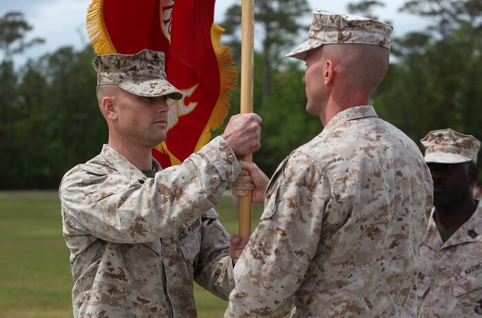 Lt. Col. William P. Carroll receives the organizational colors, signifying the transfer of leadership, from Lt. Col. Matthew B. Reuter during the Combat Logistics Battalion 22 change of command ceremony at Soifert Field aboard Camp Lejeune, N.C., April 18, 2012. Carroll assumes command of CLB-22 following his tenure as the Deputy G-3 and Current Operations officer for 2nd MLG (Forward) during a deployment to Afghanistan from August 2011 to February 2012. (U.S. Marine Corps photo by Sgt. Justin J. Shemanski)