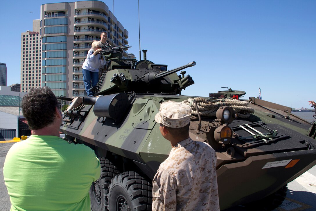 Sue Carlton of Ft. Myers, Fl., receives instruction on how to safely handle a squad automatic weapon (SAW gun) by U.S. Marine Corps 1st Lt. Karl Kurbikoff, commander of Co. A, 2nd Light Armored Reconnaissance Bn., New Orleans, La., April 18, 2012.The 26th Marine Expeditionary Unit is currently providing support to the Commemoration of the Battle of New Orleans. Starting this April and continuing through 2015, the U.S. Navy, U.S. Marine Corps and U.S. Coast Guard will commemorate the Bicentennial of the War of 1812 and the Star Spangled Banner.  The War of 1812 celebration will commemorate the rich Naval history and showcase the capabilities of today's Navy-Marine Corps team.(U.S. Marine Corps photo by Lance Cpl. Justin Williams/Released)