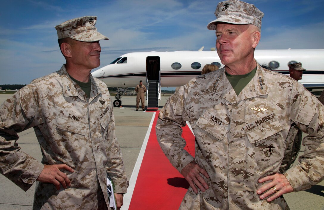 (Left to Right) Maj. Gen. Jon M. Davis, commanding general of 2nd Marine Aircraft Wing, and Commandant of the Marine Corps Gen. James F. Amos catch up and discuss the status of the wing on the Marine Corps Air Station Cherry Point flight line April 18, 2012. Sgt. Maj. of the Marine Corps Micheal P. Barrett accompanied Amos on the trip, during which they discussed the future vision of the Corps with officers and senior enlisted.