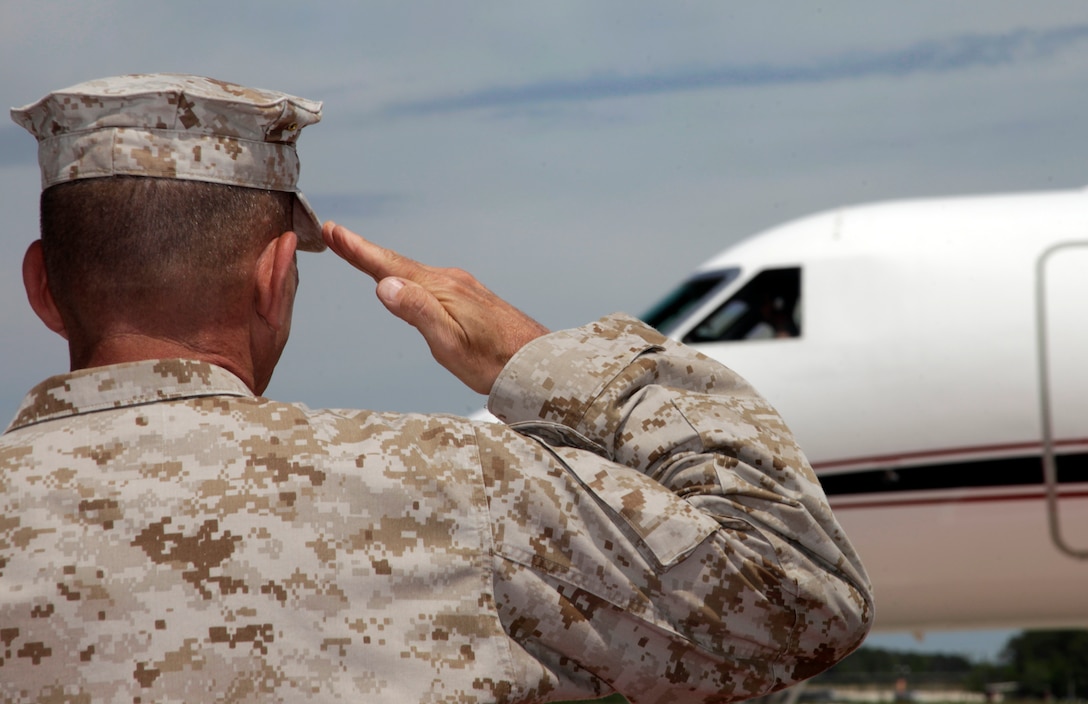 Maj. Gen. Jon M. Davis, commanding general of 2nd Marine Aircraft Wing, renders a salute for the arrival of Commandant of the Marine Corps Gen. James F. Amos on the Marine Corps Air Station Cherry Point flight line April 18, 2012. In welcoming Amos, Davis assured him his wing and Marines are executing their jobs exceptionally.