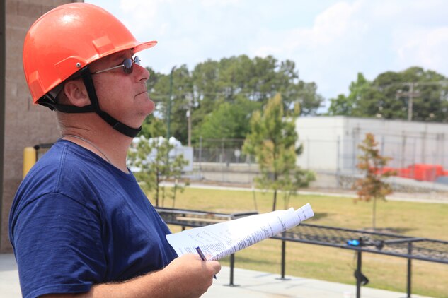 Air Station firefighter and emergency medical technician James Dotelle takes part in a training exercise as the incident commander at the Structural Fire Depart¬ment, April 18.