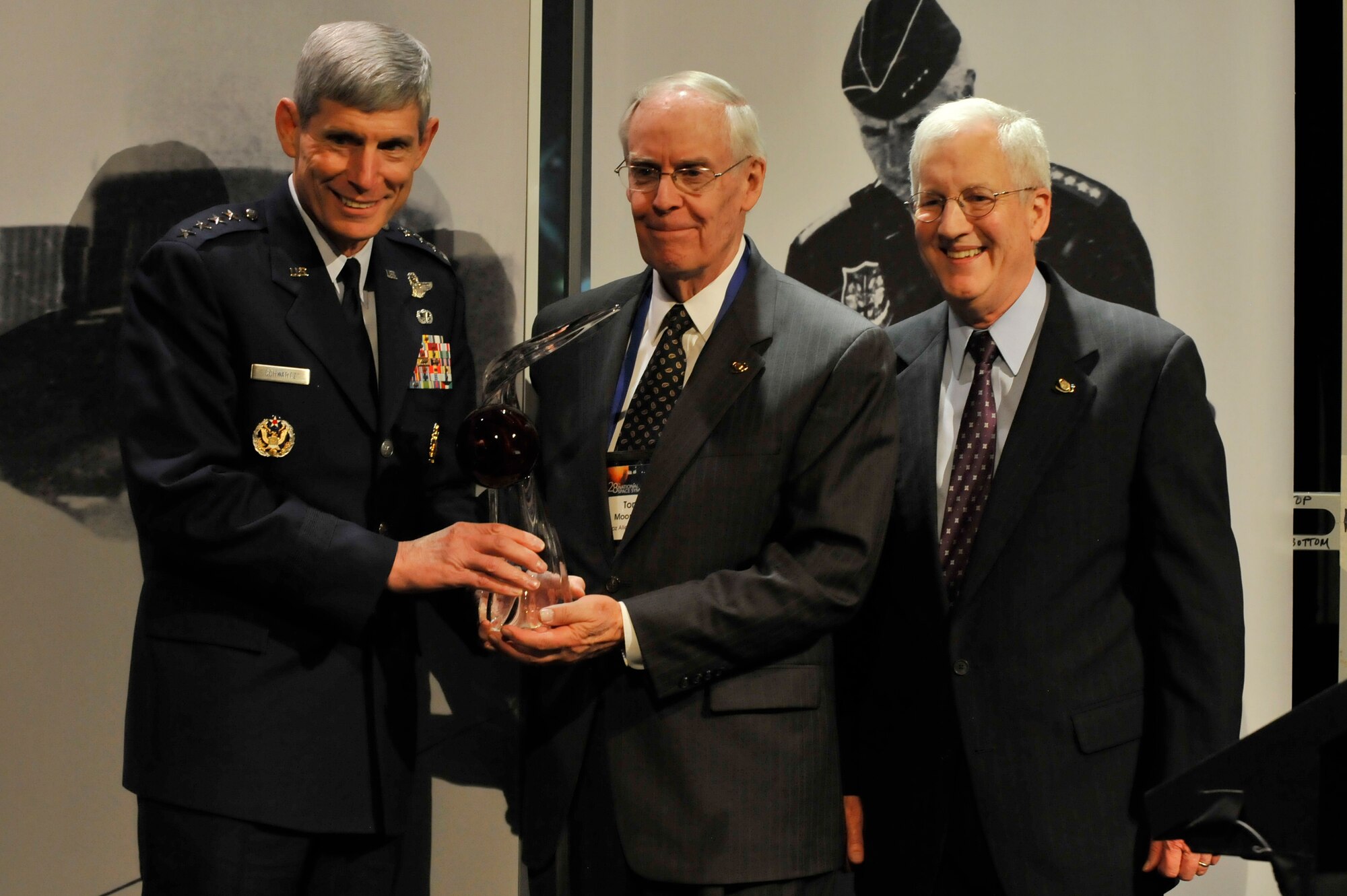 Air Force Chief of Staff Gen. Norton Schwartz presents retired Gen. Thomas S. Moorman Jr. (center) with the Gen. James E. Hill Lifetime Space Achievement Award April 18, 2012, at the 28th National Space Symposium in Colorado Springs, Colo.  With them is Martin Faga, chairman of the board for the Space Foundation.  The award is the highest honor bestowed by the Space Foundation, a nonprofit organization that supports the global space industry through information and education programs.  When he retired in August 1997, Moorman was Air Force vice chief of staff.  He previously served as Air Force Space Command commander and vice commander.  (U.S. Air Force photo by Staff Sgt. Christopher Boitz/Released)

