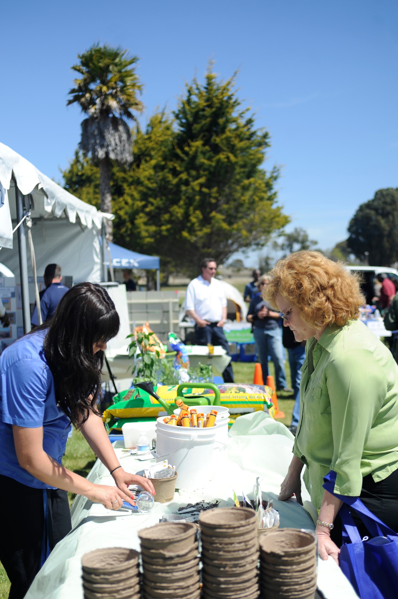 VANDENBERG AIR FORCE BASE, Calif. --Brandi Lytle, a Balfour Beatty LifeWorks coordinator, creates a miniature greenhouse out of recycled material during an Earth Day event here Wednesday, April 18, 2012. More than 25 base and local organizations participated in this environmental awareness campaign. (U.S. Air Force photo/Staff Sgt. Andrew Satran) 

 

 