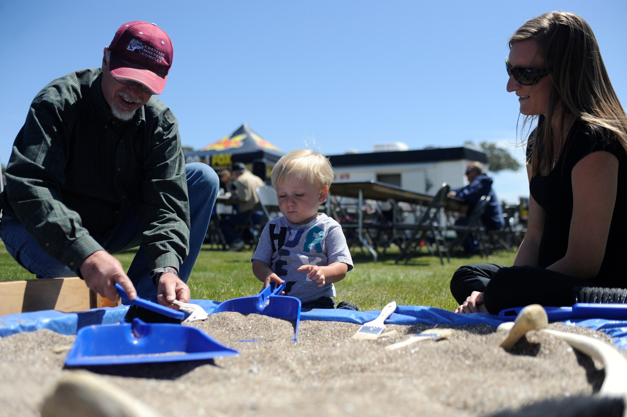 VANDENBERG AIR FORCE BASE, Calif. --Bob Peterson, a 30th Civil Engineer Squadron archaeologist, shows Jackson and Heather Smith, Air Force dependents, how he digs for artifacts on base during an Earth Day event here Wednesday, April 18, 2012. More than 25 base and local organizations participated in this environmental awareness campaign. (U.S. Air Force photo/Staff Sgt. Andrew Satran) 

 

 