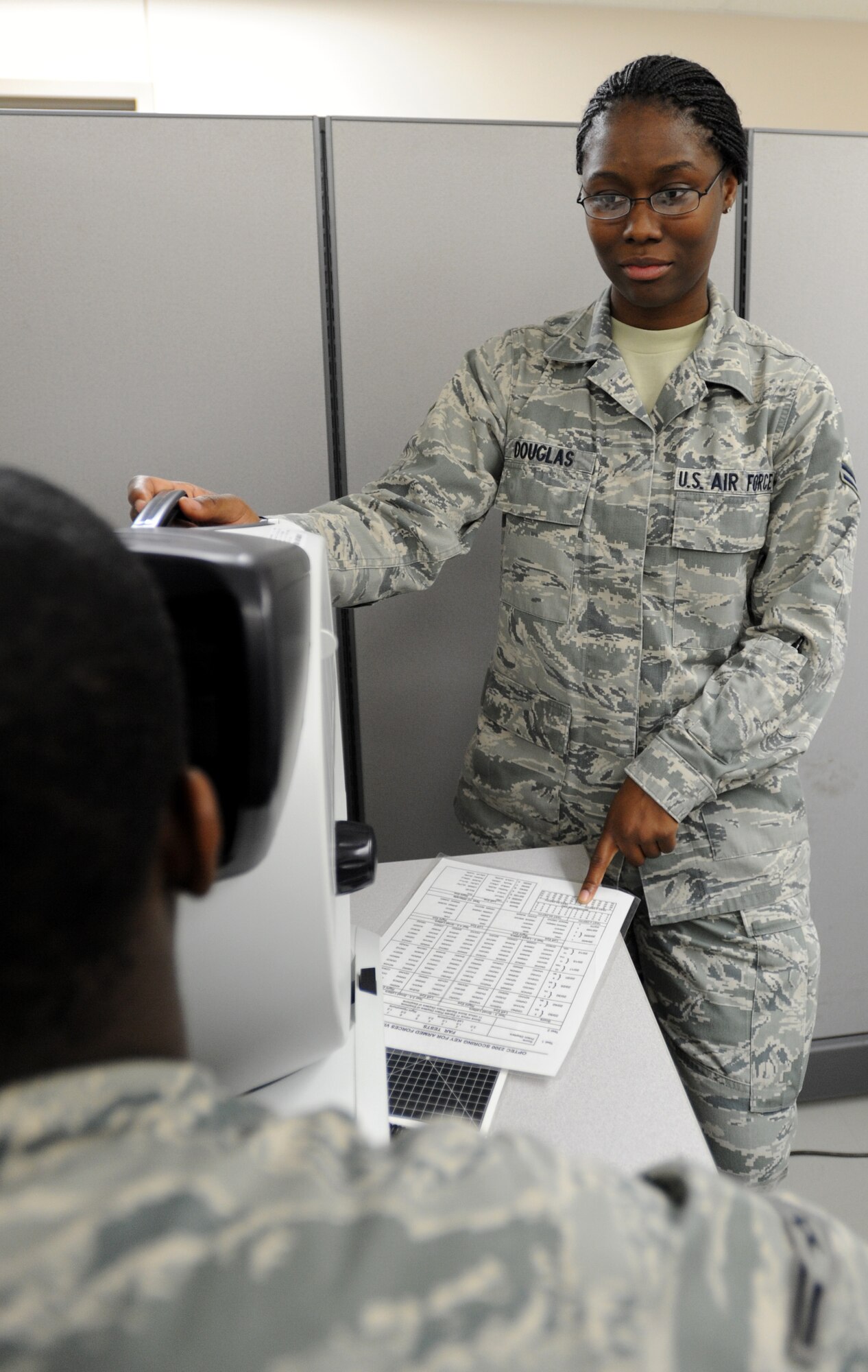 Airman 1st Class La'Gail Douglas, 22nd Aerospace Medicine Squadron services technician, administers an ocular vision test, to determine if an Airman needs glasses  April 17, 2012, McConnell Air Force Base, Kan. As a services technician, Douglas is responsible for ensuring Airmen are medically qualified to fly. Douglas was chosen as the 22nd AMDS spotlight performer for the week, April 16 to 20. (U.S. Air Force photo/ Airman 1st Class Laura L. Valentine)
