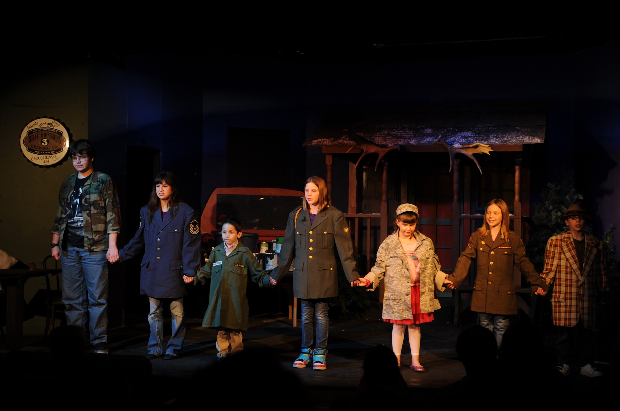 Cast members of the play "Deployed" stand together and sing a "Thank You" song to service members during a performance April 13, 2012, at the Fire Hall Theater in Grand Forks, N.D. Students from Grand Forks Air Force Base, N.D., served as inspiration for the play. (U.S. Air Force photo/Staff Sgt. Amanda N. Grabiec)