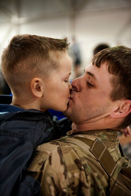 U.S. Air Force Staff Sgt. Casey Strauss, a special operations forces fly away security team from 1st Special Operations Security Forces Squadron, kisses his son Carter at the 16th Aircraft Maintenance Unit hangar on Hurlburt Field, Fla., April 6, 2012. Strauss was met by family members after serving a deployment in support of overseas contingency operations. (U.S. Air Force photo/Airman 1st Class Christopher Williams)
